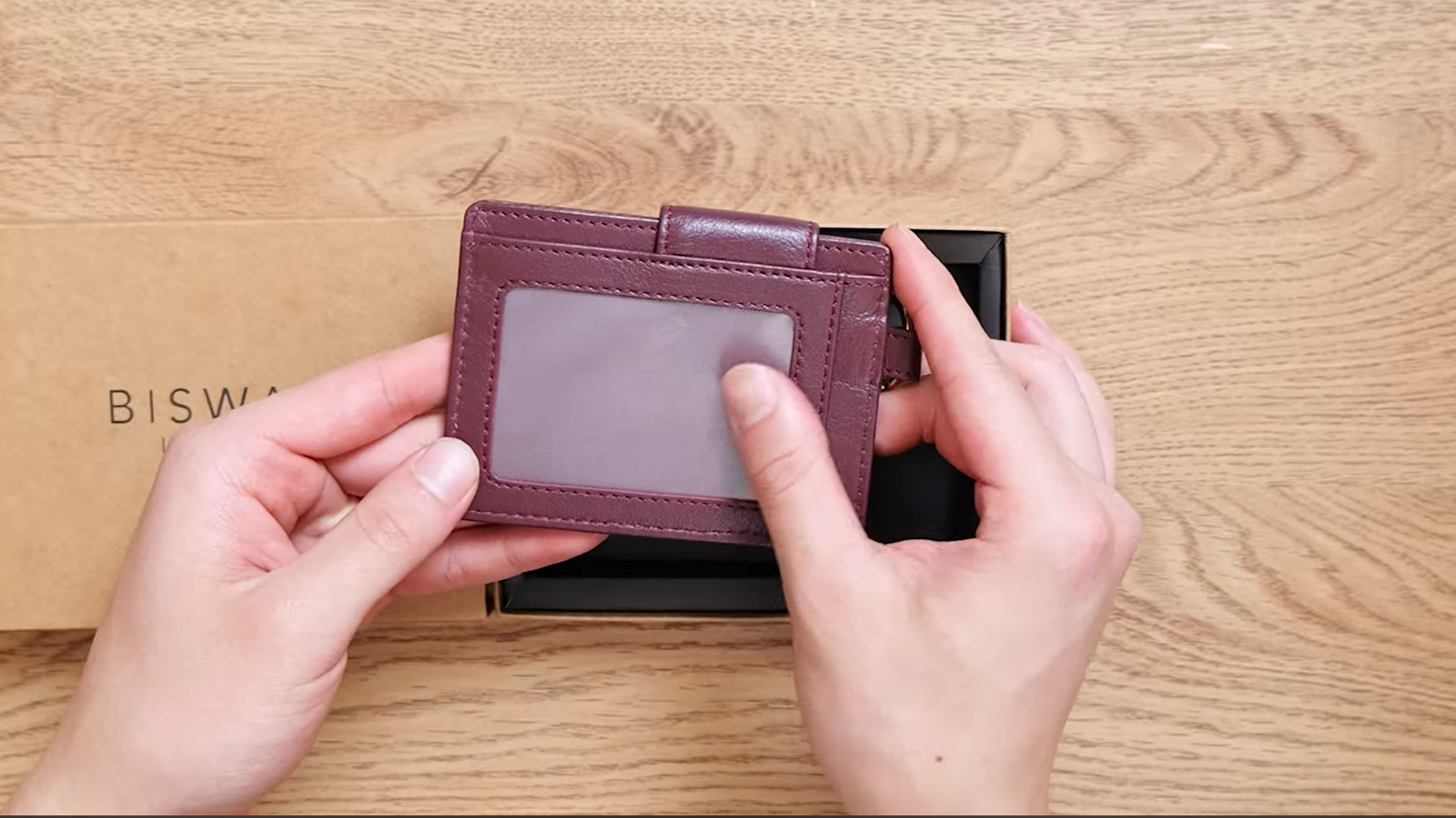 The Attaché leather card holder in Oxblood, shown in hand