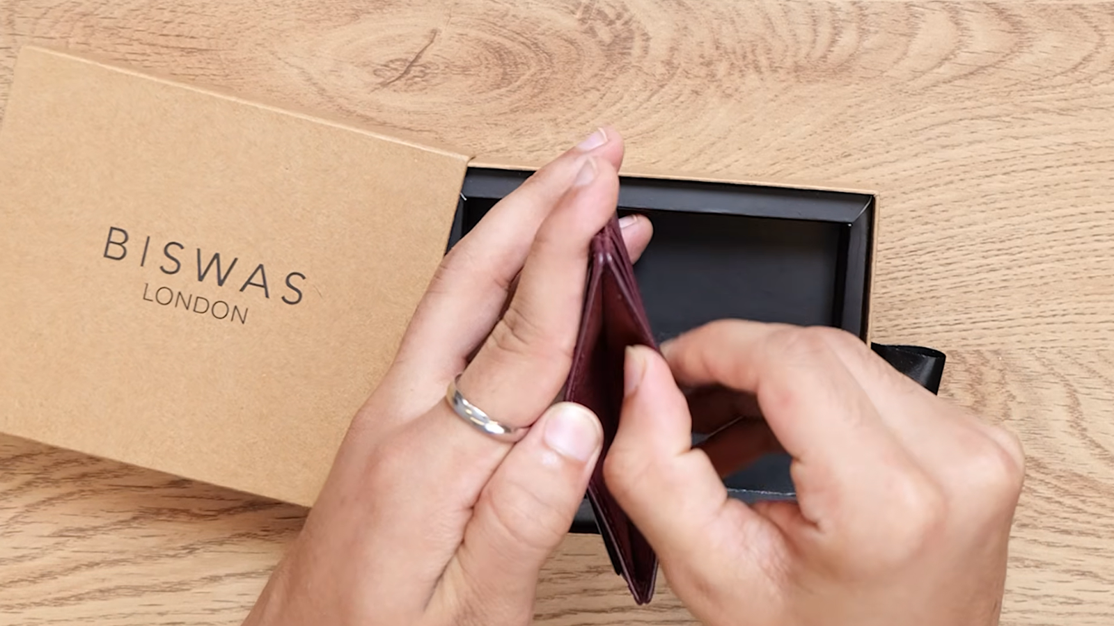 The Diplomat leather card holder in Oxblood, shown in hand