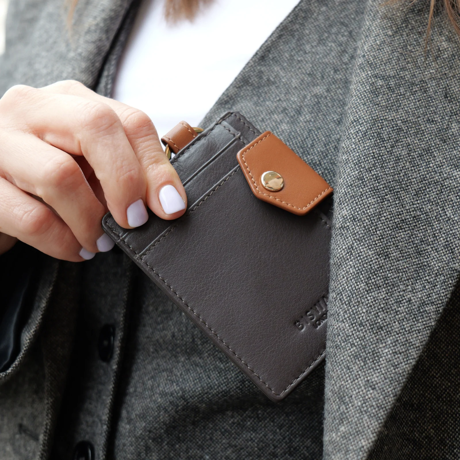 Espresso cardholder with frosted matte ID window shown in hand