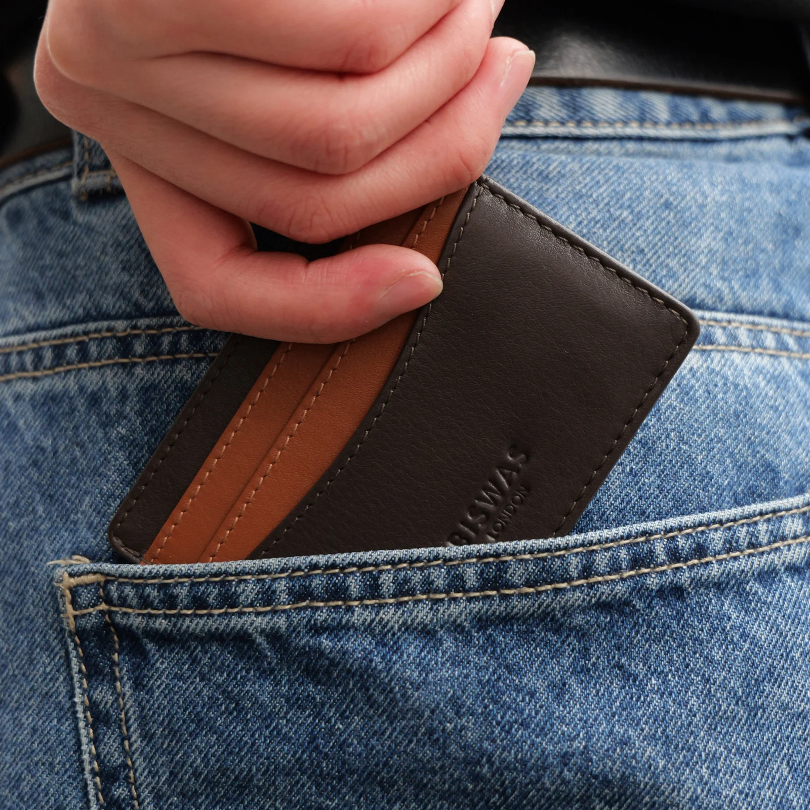 Slim Espresso leather cardholder held in one hand